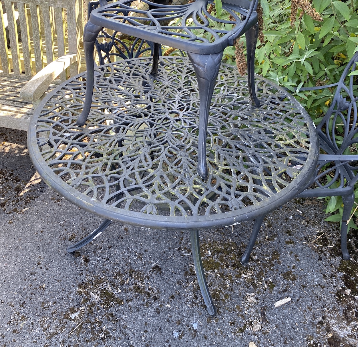 A circular painted aluminium garden table and three chairs, table 120cm diameter, height 72cm